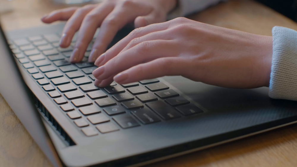 hands typing on computer keyboard