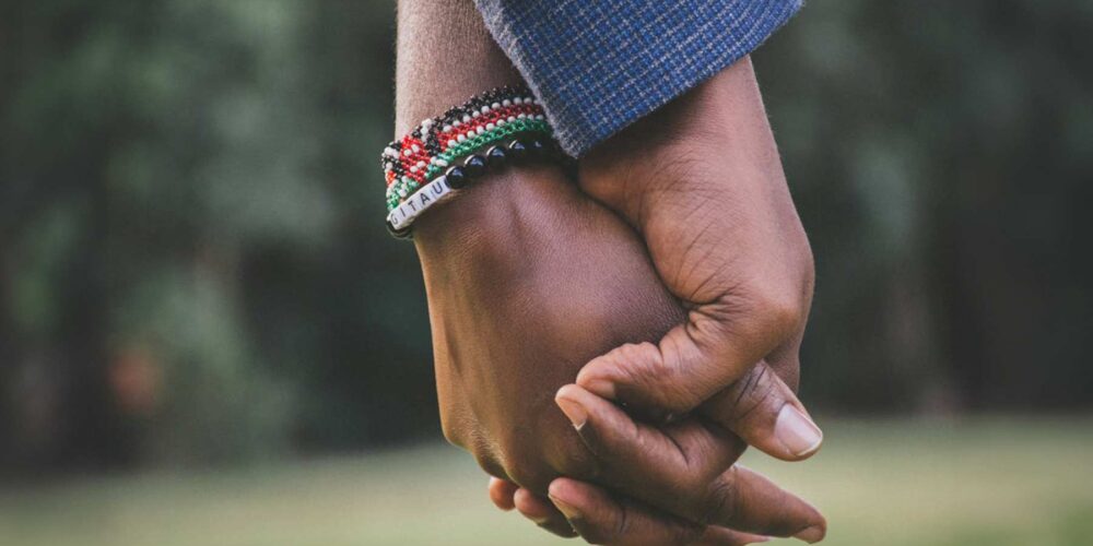 This image shows a close-up of two hands held together, symbolizing support and companionship.