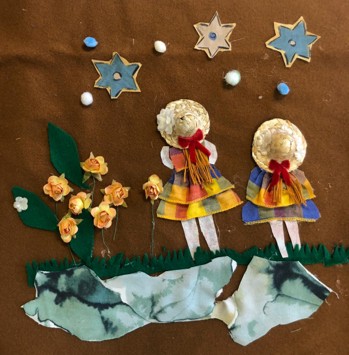 Figure 2 - Quilt panel depicting two girls standing among flowers and looking out towards a stary sky.